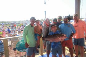 5 men and 2 boys at Fishing Tournament with the fish they caught